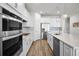 Bright, white kitchen with stainless steel appliances, subway tile backsplash, and a large island with sink at 7649 Ragusa Way, Clermont, FL 34714