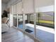 View of covered lanai from inside, featuring sliding glass doors and privacy shades at 7649 Ragusa Way, Clermont, FL 34714