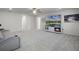Living room featuring a gray carpet, fireplace, and tv at 7649 Ragusa Way, Clermont, FL 34714