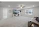 Spacious living room with a cozy fireplace and gray carpeting at 7649 Ragusa Way, Clermont, FL 34714