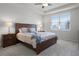 Bright main bedroom featuring a ceiling fan, a window with blinds, and well-coordinated furnishings at 7649 Ragusa Way, Clermont, FL 34714