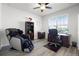 Home office featuring wood floors, a ceiling fan, window, desk, chair and massage chair at 7649 Ragusa Way, Clermont, FL 34714