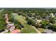 A beautiful aerial view of a community on a golf course with mature trees and landscaping at 7655 Persian Ct, Orlando, FL 32819