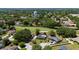 An aerial view of a home overlooking a lush golf course and a scenic community at 7655 Persian Ct, Orlando, FL 32819