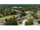 Aerial view of home with lush golf course and mature trees at 7655 Persian Ct, Orlando, FL 32819
