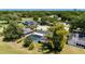 An aerial view displays the pool, landscaping, mature trees, and proximity to the golf course at 7655 Persian Ct, Orlando, FL 32819