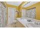 Bright bathroom featuring double sinks, white vanity, and shower-tub combination at 7655 Persian Ct, Orlando, FL 32819