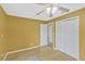 This spacious bedroom has a ceiling fan and closet space at 7655 Persian Ct, Orlando, FL 32819