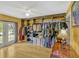 A spacious walk-in closet is enhanced by a ceiling fan and french doors overlooking the yard at 7655 Persian Ct, Orlando, FL 32819