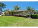 The front yard of this house includes neatly manicured landscaping, mature trees and great curb appeal at 7655 Persian Ct, Orlando, FL 32819