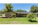 Charming single-story home featuring stone accents, a well-manicured lawn, and mature landscaping at 7655 Persian Ct, Orlando, FL 32819