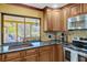 Modern kitchen with stainless steel appliances, granite countertops and a view of the screened lanai at 7655 Persian Ct, Orlando, FL 32819