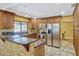 Updated kitchen with stainless steel appliances, granite counters and breakfast bar with views to backyard at 7655 Persian Ct, Orlando, FL 32819