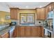 Modern kitchen with stainless steel appliances, granite countertops, and a large window above the sink at 7655 Persian Ct, Orlando, FL 32819