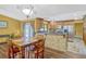 Kitchen and dining area featuring wood floors, natural wood cabinets, stainless appliances and backyard access at 7655 Persian Ct, Orlando, FL 32819