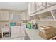 Functional laundry room with utility sink and ample storage cabinets for convenience at 7655 Persian Ct, Orlando, FL 32819