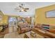Inviting living room with hardwood floors, leather seating, and backyard access at 7655 Persian Ct, Orlando, FL 32819