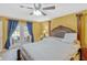 Spacious main bedroom featuring french doors with pool view, ceiling fan, and ensuite bath at 7655 Persian Ct, Orlando, FL 32819