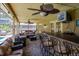 Covered outdoor patio with bar seating and relaxing lounge area, perfect for entertaining guests at 7655 Persian Ct, Orlando, FL 32819