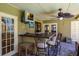 Outdoor patio with bar seating and ceiling fans providing a comfortable space for enjoying the outdoors at 7655 Persian Ct, Orlando, FL 32819