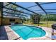 Sparkling screened in pool with brick patio and landscaped backyard at 7655 Persian Ct, Orlando, FL 32819