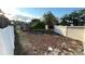 A spacious backyard featuring a white fence, lush greenery, and a charming gazebo, perfect for outdoor enjoyment at 7730 Broken Arrow Trl, Winter Park, FL 32792