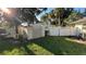A well maintained backyard features lush lawn, shed, and white fencing at 7730 Broken Arrow Trl, Winter Park, FL 32792