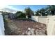 A spacious backyard featuring a white fence, lush greenery, and a charming gazebo, perfect for outdoor enjoyment at 7730 Broken Arrow Trl, Winter Park, FL 32792