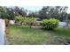 A backyard with a vibrant green lawn, showcasing lush landscaping and a charming gazebo in the background at 7730 Broken Arrow Trl, Winter Park, FL 32792