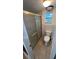Bathroom with toilet, window, tile floor, and a glass-enclosed shower at 7730 Broken Arrow Trl, Winter Park, FL 32792