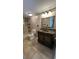 Updated bathroom with custom vanity, tile surround, and updated fixtures at 7730 Broken Arrow Trl, Winter Park, FL 32792