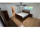 Bedroom with stylish furnishings, wood floors, and a ceiling fan for added comfort at 7730 Broken Arrow Trl, Winter Park, FL 32792