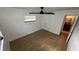 This bedroom has wood look floors, a ceiling fan, and a nearby full bathroom at 7730 Broken Arrow Trl, Winter Park, FL 32792
