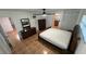 Spacious bedroom with ceiling fan, wood floors, and direct access to kitchen and bathroom at 7730 Broken Arrow Trl, Winter Park, FL 32792
