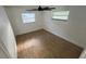 Bedroom with neutral paint, tile flooring, and bright natural light from two windows at 7730 Broken Arrow Trl, Winter Park, FL 32792