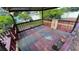 A covered wooden deck featuring a wooden railing, partially worn covering, and potted plants at 7730 Broken Arrow Trl, Winter Park, FL 32792