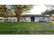 Charming single-story home featuring a well-maintained lawn and front landscaping at 7730 Broken Arrow Trl, Winter Park, FL 32792