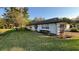 Well-maintained single-story home with a two-car garage and landscaped front yard at 7730 Broken Arrow Trl, Winter Park, FL 32792