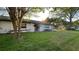 Charming single-story home with lush front lawn and mature trees in a quiet neighborhood at 7730 Broken Arrow Trl, Winter Park, FL 32792