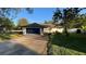 A well maintained single Gathering home with a two-car garage and manicured lawn at 7730 Broken Arrow Trl, Winter Park, FL 32792