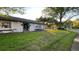 Attractive single-story home with well-maintained lawn and landscaping under the sunlight at 7730 Broken Arrow Trl, Winter Park, FL 32792