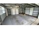 A clean, spacious garage featuring ample storage, multiple doors, and good lighting at 7730 Broken Arrow Trl, Winter Park, FL 32792