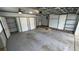 A clean, spacious garage featuring ample storage, multiple doors, and good lighting at 7730 Broken Arrow Trl, Winter Park, FL 32792
