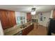 Well-equipped kitchen with granite countertops, wooden cabinets, and stainless steel appliances at 7730 Broken Arrow Trl, Winter Park, FL 32792