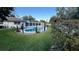 A private backyard oasis features an in-ground pool and well-maintained landscaping at 7730 Broken Arrow Trl, Winter Park, FL 32792