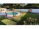 Backyard view showcasing a sparkling in-ground pool and well-maintained lawn at 7730 Broken Arrow Trl, Winter Park, FL 32792