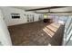 Large sunroom with exposed beams, neutral tile flooring, and a hot tub at 7730 Broken Arrow Trl, Winter Park, FL 32792