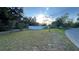 Expansive grassy lot framed by mature trees and a white fence, offering privacy and scenic views at 7730 Broken Arrow Trl, Winter Park, FL 32792