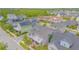 An elevated view of a two-story home with manicured landscaping and mature trees in a serene neighborhood setting at 7831 Dausset St, Orlando, FL 32827