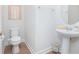 Half bathroom features a pedestal sink and a modern toilet with stylish decor at 7831 Dausset St, Orlando, FL 32827